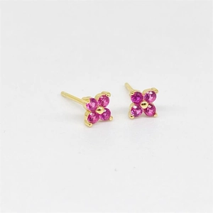 Detail of S925 sterling silver four-leaf clover stud earrings with rose red gemstones