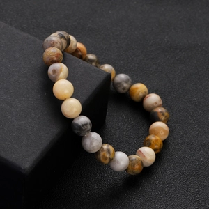 Close-up of natural colorful chalcedony agate beads on a black square display box