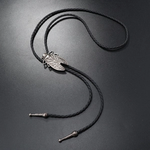 Close-up of cicada-shaped metal slider on a black braided western bolo tie necklace