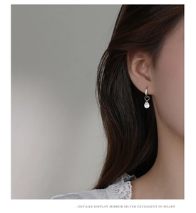 Detailed close-up of S925 sterling silver hoop earrings with water drop zircon pendant
