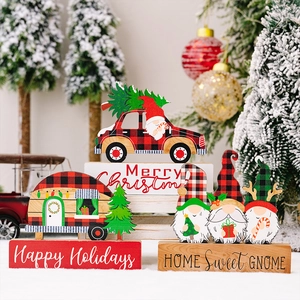 Festive Christmas wooden gnomes and red plaid truck tabletop decorations on faux snow