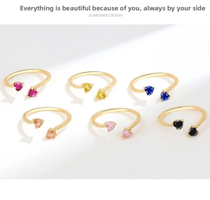 Detailed set of six beaded gold rings featuring colorful heart-cut zircons on white backdrop