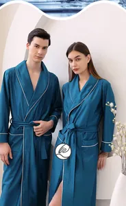 Detail of lake blue waffle texture satin bathrobe with white contrast piping and belt