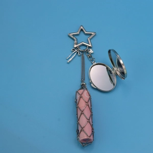 Pink lipstick net pouch keychain with star carabiner and oval mirror on blue background
