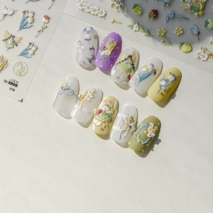 Macro detail of 3D embossed floral nail stickers with cute rabbit and tulip designs
