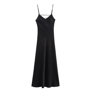 Close-up of black satin slip dress showing V-neckline detail and silky fabric texture