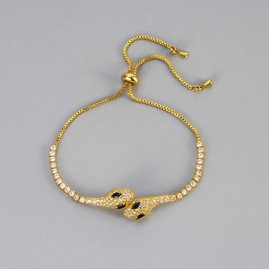 Luxurious gold-tone double snake head bolo bracelet with sparkling white crystal pavé