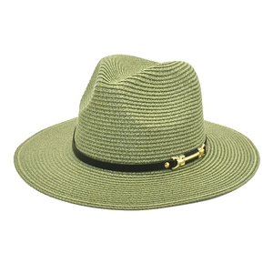 Detail of light olive wide brim straw hat featuring black ribbon and gold buckle