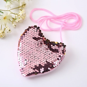 Detail view of pink heart-shaped sequin purse with matching woven shoulder strap