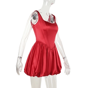 Detail of red satin bodycon dress featuring a flared bubble hem and glossy silk texture