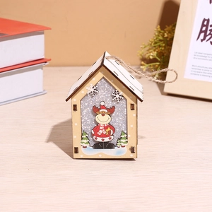 Detail of wooden Christmas house hanging with reindeer and silver glitter background