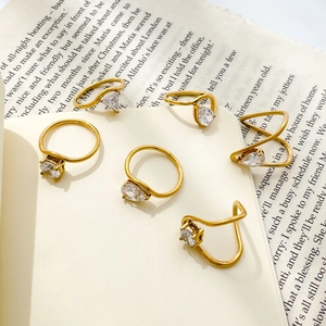 6-piece gold ring set featuring teardrop and circular zircon stones in a minimalist style