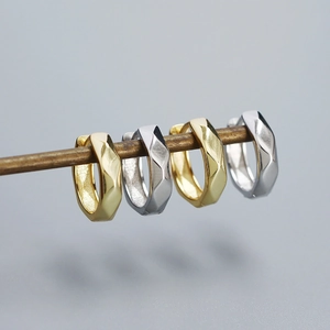 S925 silver irregular faceted hoop earrings in gold and silver set on a metal bar
