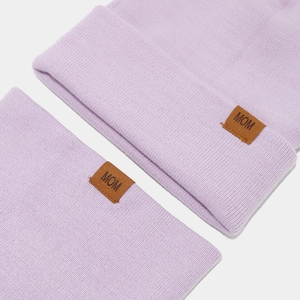 Close-up of lavender knitted beanie with a MOM leather patch and soft ribbed texture