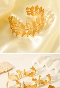 Macro detail of 18K gold plated leaf and flower patterns on open cuff bracelets