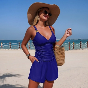 Détail du haut de tankini bleu roi avec décolleté en V, fronces et anneaux dorés élégants