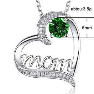 Macro detail of MOM heart pendant with green 5mm gemstone and 3.5g weight info