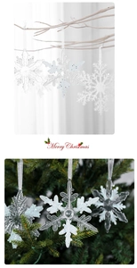 Hollow acrylic snowflake ornament with iridescent glitter hanging on a festive Christmas tree