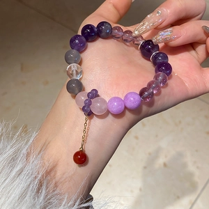 Macro shot of colorful agate and amethyst beaded bracelet with a red stone pendant
