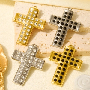 Detail of 304 stainless steel cross pendants with gold and silver cubic zirconia settings