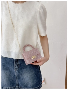 Pink jelly crossbody bag with quilted pattern, glitter effect, and beaded handle