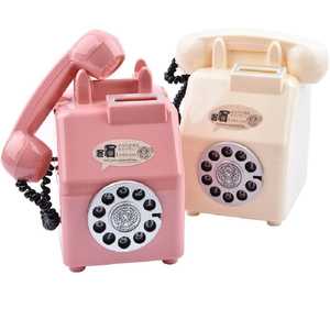 Retro rotary phone piggy banks in pink and beige colors for decorative gift purposes