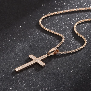 Detailed macro view of a rose gold cross pendant with sparkling inlaid crystals