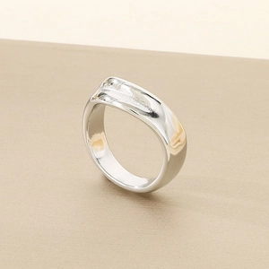 Macro detail of molten texture and polished surface on wide stainless steel ring
