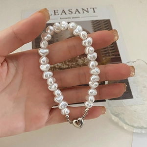 French vintage freshwater pearl bracelet with a silver heart magnetic clasp worn on wrist