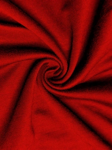 Macro view of deep red knit fabric showing soft texture and fine horizontal weave details