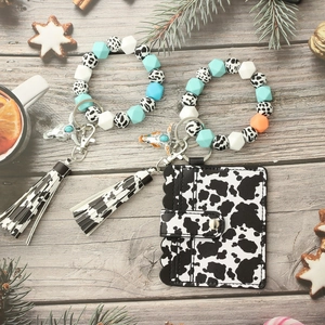 Cow print silicone bead keychain bracelet with matching leather card holder and tassel charm