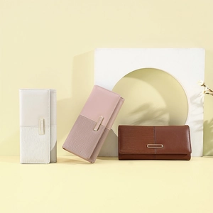 Three elegant long patchwork purses for women in beige, pink, and brown leather