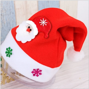 Vue détaillée du bonnet de Noël rouge avec motif Père Noël et paillettes de flocon de neige