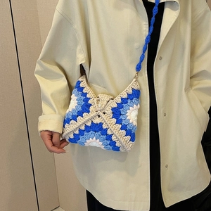 Handmade crochet sunflower crossbody bag with colorful granny square patterns and pearl button