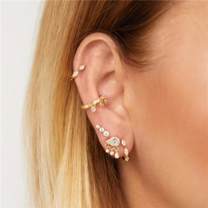 Close-up of S925 sterling silver gold earrings set with zircon studs on ear lobe