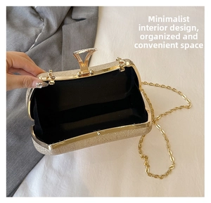Macro view of gold glitter evening bag with chain and sparkly triangular diamond clasp