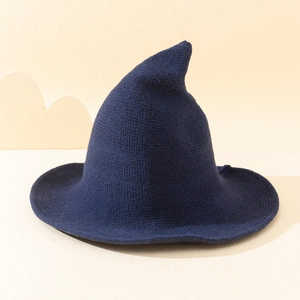 Knitted witch hat for women featuring a pointed top and wide brim in dark blue yarn