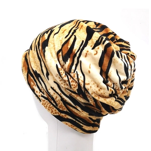 Close-up of zebra pattern turban hat showing soft texture and elastic knitted fabric details