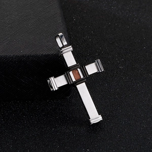 Detailed view of stainless steel cross pendant featuring textured wood inlay detail