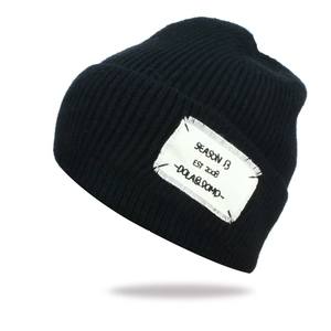 Detail of black ribbed knit beanie with a white vintage SEASON B fabric patch logo