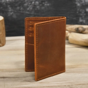Detailed macro view of the interior card slots and stitching on the brown leather wallet