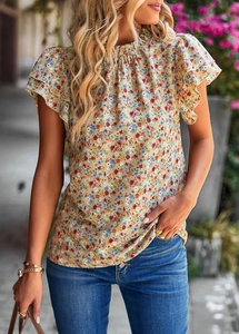 Detail of ruffle sleeves and delicate floral print on a beige summer casual blouse