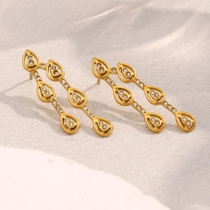 Detail of 18K gold plated teardrop stud earrings featuring inlaid white zircon stones