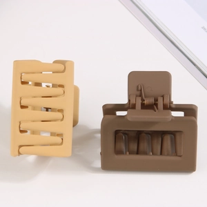 Matte square hair claw clips in beige and brown colors shown on a white surface