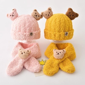 Detail of plush bear ear hat and matching scarf set for kids in pink and yellow colors