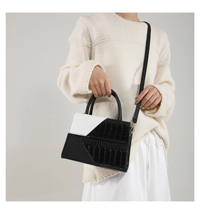 Chic black and white PU leather square handbag with faux crocodile texture shown on model