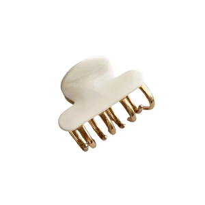 Minimalist white acetate and gold metal shark hair claw clip for elegant half-up hair styling