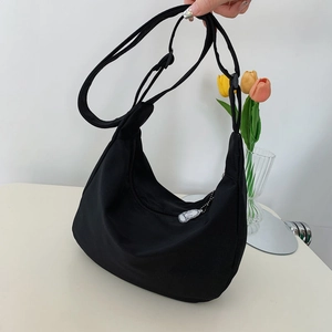 Large capacity black crescent crossbody bag with adjustable strap and cute dog pendant