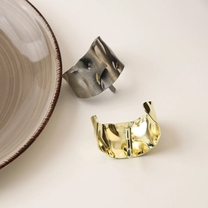 Detailed macro view of metal hair clip with hammer texture in gold and gun black finish