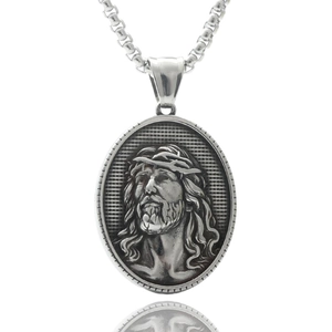 Macro detail of silver Jesus portrait pendant in stainless steel with relief texture